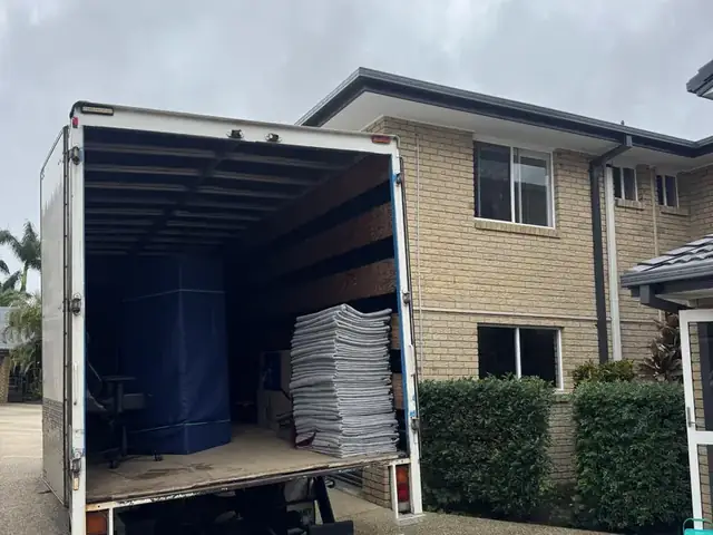 Back of a Safepack removal truck open at a brick Gold Coast home during a move