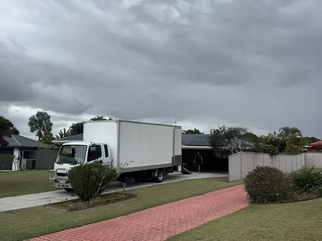 Safepack removal truck parked in a quiet Gold Coast street on a cloudy day